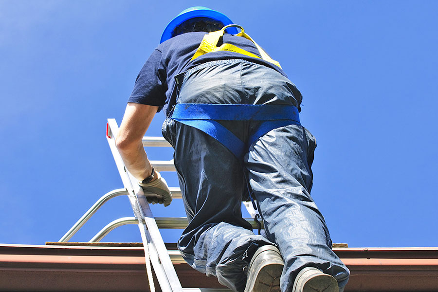 Roofer Inspecting Roof