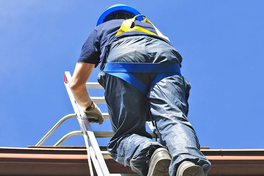 Roofer Inspecting Roof