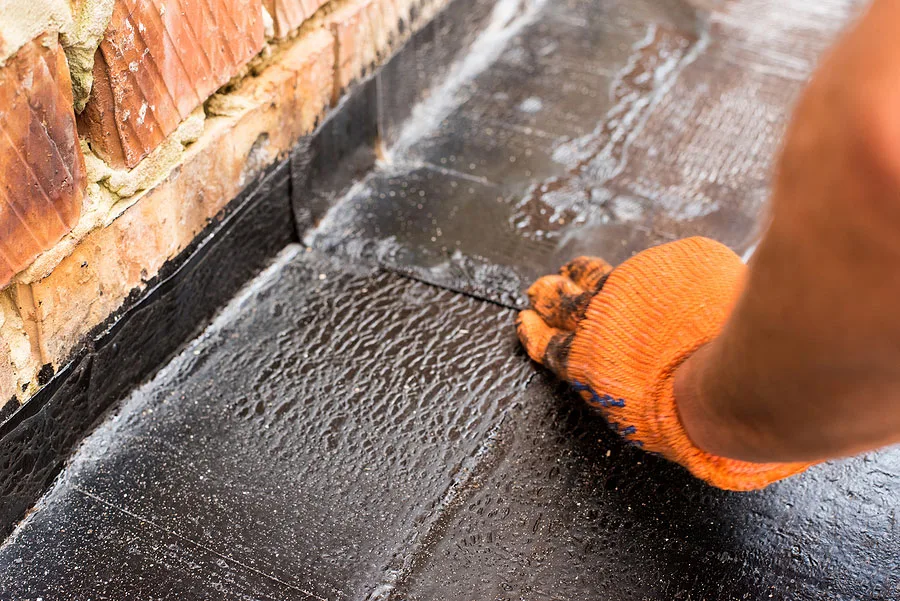Roofer Making a Repair to a Residential Flat Roof